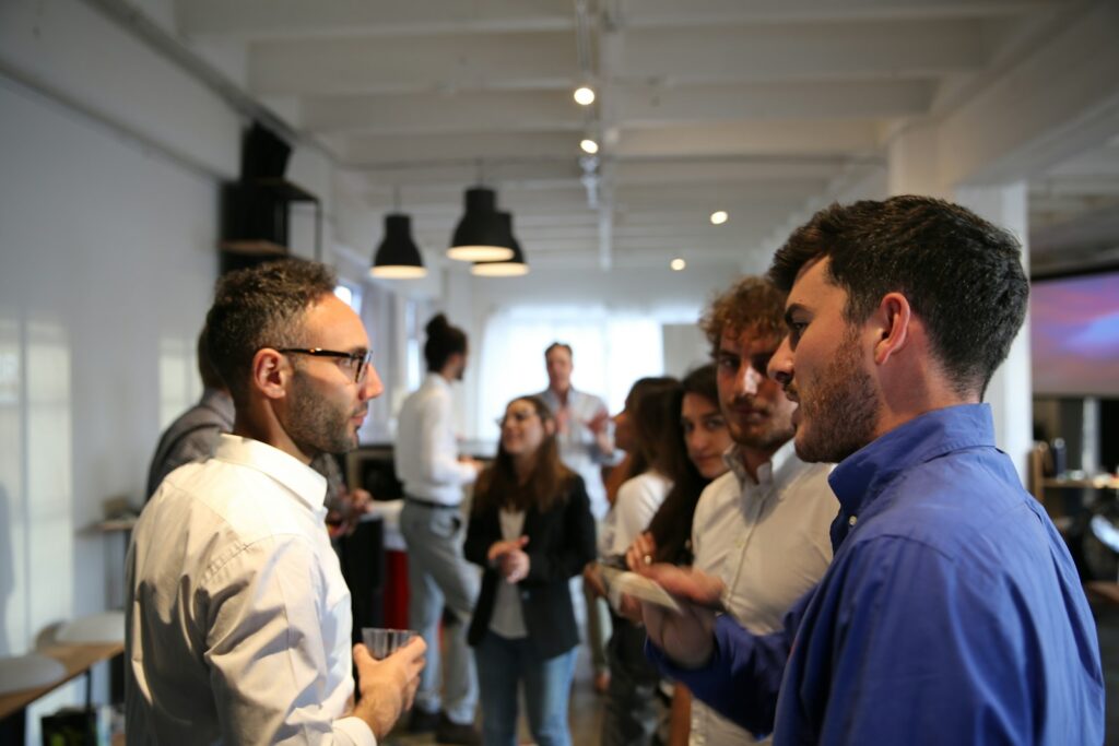 Personas conversando de pie durante un evento profesional